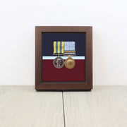 RAF Medal Display Case with single mounted medal and RAF belt background