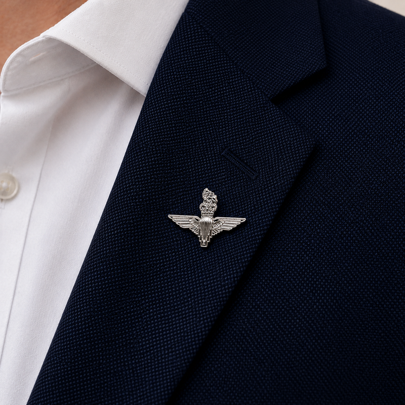 silver parachute regiment lapel badge on a navy blue suit jacket